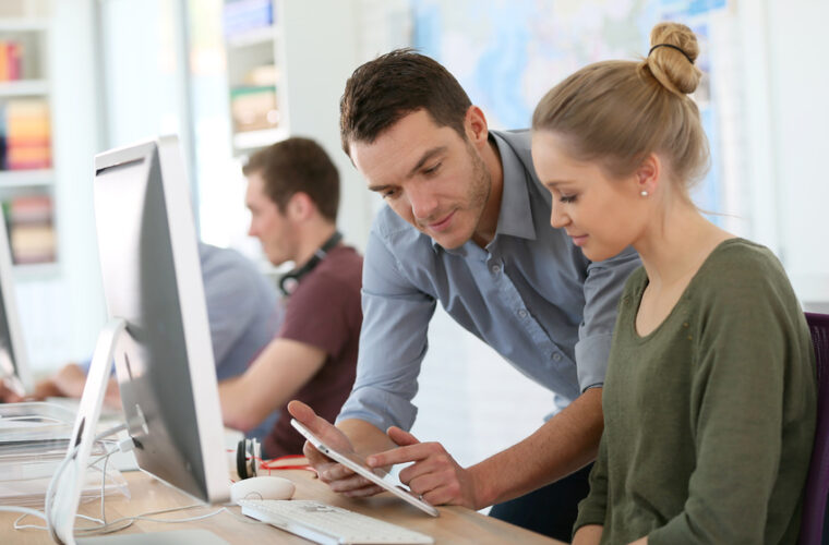 Student girl with trainer working on computer and tablet